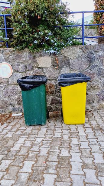istock Large plastic trash cans in green and yellow. 2191320666