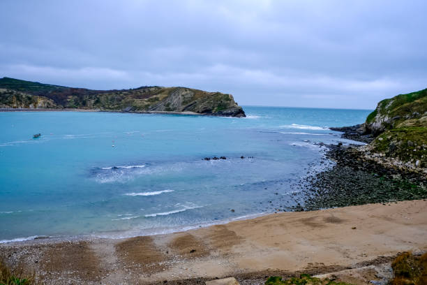 Lulworth Cove and beach view at winter day. Lulworth Cove bay, beach and cliffs view . The Jurassic Coast is a World Heritage Site on the English Channel coast of southern England. Dorset, UK. public beach