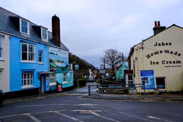 Lulworth Cove, Dorset, UK - 17.12.2024. Main Street view. Facades of charming cafes, hotels, shops in Lulworth Cove village in Dorset, England, UK Charming rural English countryside. street view of cozy old medieval village. High street. Winter, autumn in England.