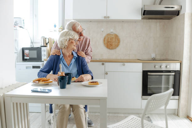 istock Joyful senior couple enjoying in the kitchen and having breakfast 2191322429