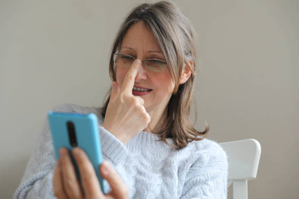 istock Comfortable Woman Smiling at Smartphone Indoors 2191323139