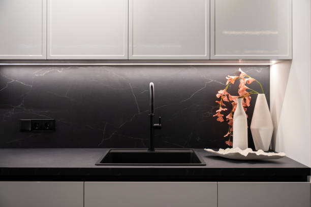 istock Elegant semicircular kitchen faucet with granite countertop and sink 2191323357