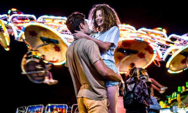 istock Couple having fun in an amusement park 2191324790