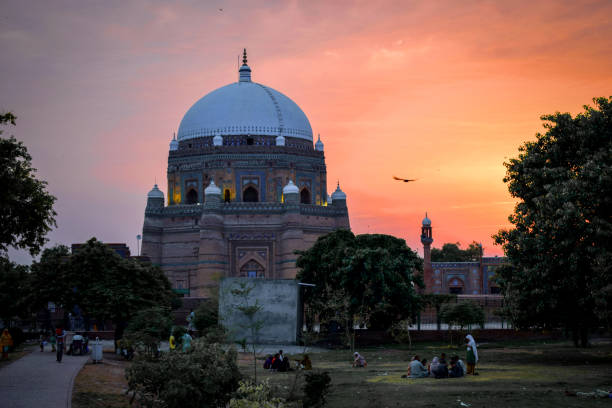 Black and white image of Weathered brick arches and domed pavilions rise from a crumbling fortress, evoking history and forgotten charm. The sunlit structure blends rustic texture with timeless regional design, ideal for heritage and travel themes.
