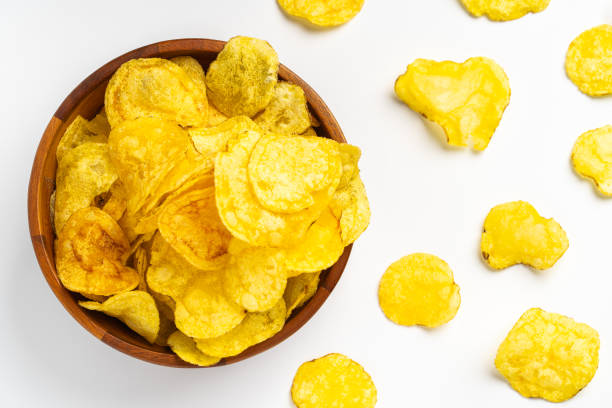 istock Crispy peruvian yellow potato chips overflowing a wooden bowl 2191325289