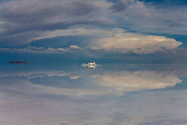 The line which divides the sky and the land is barely discernible and it is hard to tell what is real and what is reflection. In the world's biggest salt desert, measuring 12,000 sq km (4,635 sq miles), the ground at certain times of the year resembles a giant mirror. Salar de Uyuni is the world's largest salt flat, at over 10,000 square kilometres in area It is in the Daniel Campos Province in Potosí in southwest Bolivia, near the crest of the Andes at an elevation of 3,656 m above sea level. The Salar was formed as a result of transformations between several prehistoric lakes that existed around forty thousand years ago but had all evaporated over time. It is now covered by a few meters of salt crust, which has an extraordinary flatness with the average elevation variations within one meter over the entire area of the Salar. The crust serves as a source of salt and covers a pool of brine, which is exceptionally rich in lithium.