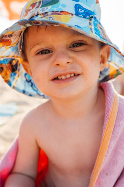 istock Smiling baby on a sandy beach 2191330471