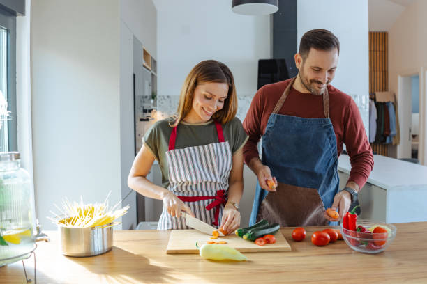 istock Couple preparing a healthy meal together in their modern home kitchen 2191331663