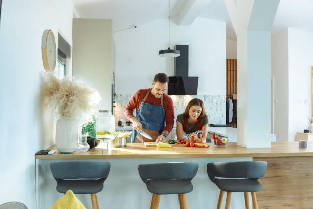 istock Couple preparing vegetables together in modern kitchen with natural light atmosphere 2191331688