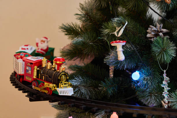 istock A Festive Christmas Train is Joyfully Decorating a Beautiful Christmas Tree with Cheer 2191332300