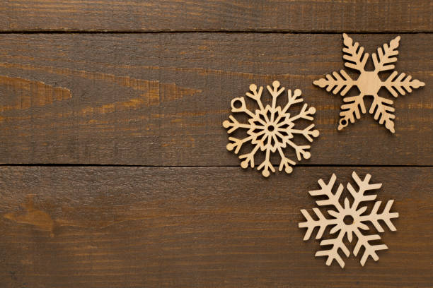 istock Beautiful snowflake on wooden background, top view 2191334621