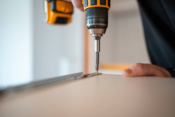istock Skilled Carpenter Attaching Cabinet Fixtures 2191337175