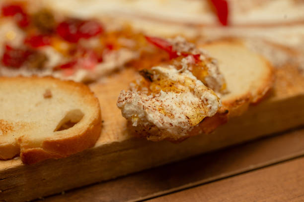The butter board brings together the perfect harmony of sweet and spicy flavors. Honey and cinnamon spread on a butter plate, walnut pomegranate flavored sausage, exotic and slightly spicy, tropical coconut toasted bread.