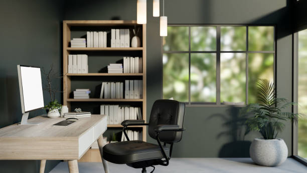 istock A modern dark green office workspace featuring a computer on a wooden table, a chair, and decor. 2191345153