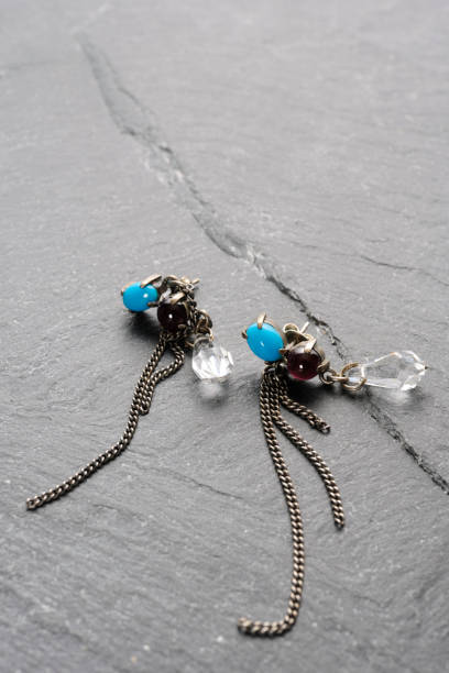 istock Rutile quartz and lapis lazuli earrings with chain on a black slate 2191353573