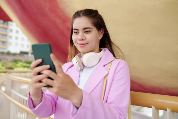 istock Portrait of Woman Using Smartphone Outdoors Smiling 2191355888