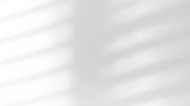 istock White wall with shadow of shutters window overlay. 2191357363