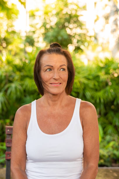 istock Happy woman smiling and sitting outdoors during summer 2191357371