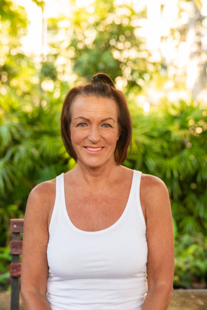istock Happy woman smiling and sitting outdoors during summer 2191357398