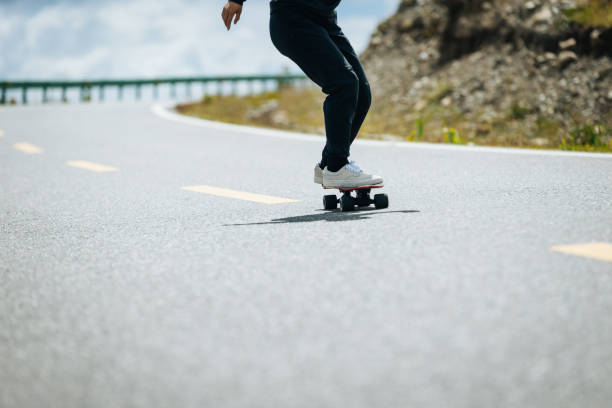 istock Skateboarder skateboarding on the mountain road 2191357954