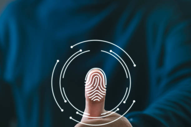Thumb pressing on a digital fingerprint scanner with futuristic circular graphics around it.