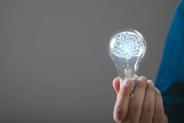 istock A creative hand holding a light bulb with a glowing brain inside, symbolizing innovative ideas and intelligence. 2191364472