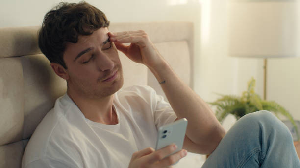 istock Caucasian European man bed using mobile phone smartphone error broken failure telephone gadget technology guy male notification displeased problem spam internet mistake social networks connect bedroom 2191365633