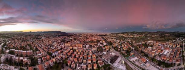 istock Panoramic cityscape at sunset with vibrant sky. 2191366375