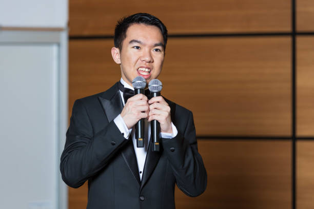 istock A young man is speaking into two microphones as an event emcee 2191367828