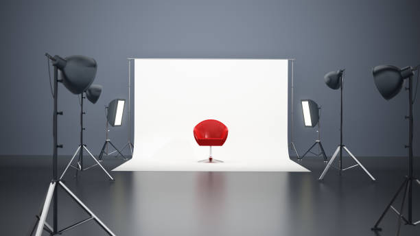 A creative studio is prepared for a photography session featuring a bright red chair as the centerpiece. Professional lights are positioned strategically around a simple backdrop. 3D illustration