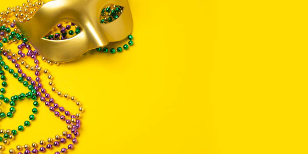 istock Mardi Gras beads on yellow background 2191370750