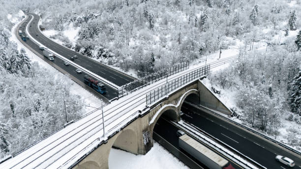 istock Snowy Railway Bridge and Highway in Winter Forest 2191372146