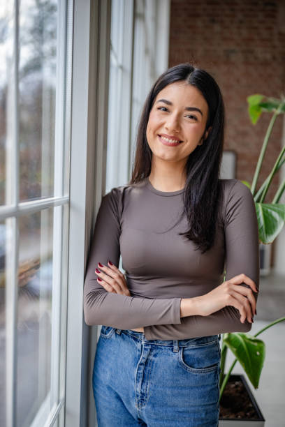 istock Woman with long hair poses by window with elegance 2191373665
