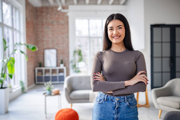 istock Woman in grey top posing in bright, modern apartment 2191373981