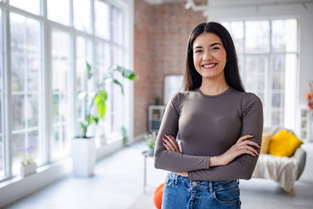 istock Smiling woman posing confidently in bright modern space 2191374006