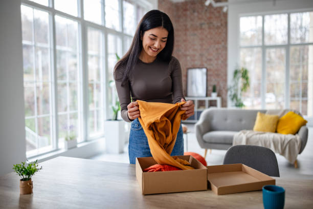 istock Woman appreciating new fabric she has just unpacked. 2191374511