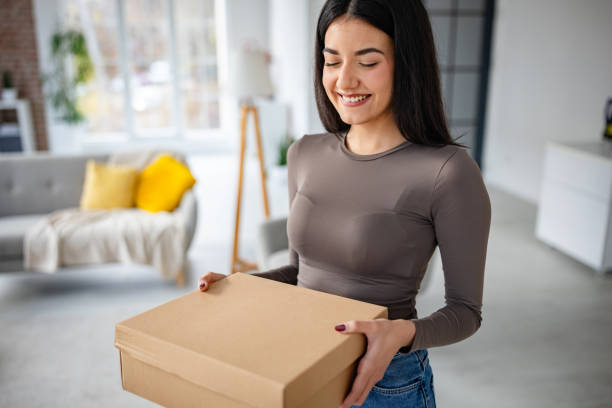 istock Content woman ready to open a cardboard package 2191375342