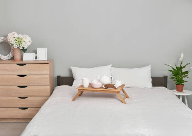 istock Breakfast in bed in hotel room. Accommodation. Breakfast in bed with tea cup with pancakes on tray on bed background top view.Copy Space. Romantic valentine's day breakfast. Cozy breakfast and morning 2191375452