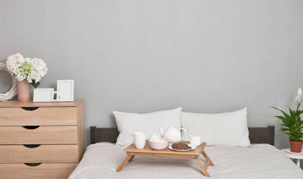 istock Breakfast in bed in hotel room. Accommodation. Breakfast in bed with tea cup with pancakes on tray on bed background top view.Copy Space. Romantic valentine's day breakfast. Cozy breakfast and morning 2191375455