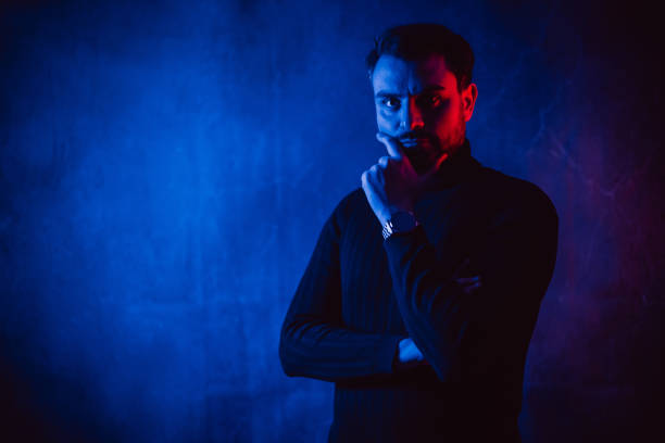 istock Serious Mid-Adult Man Standing Under Blue Neon Lights 2191376213