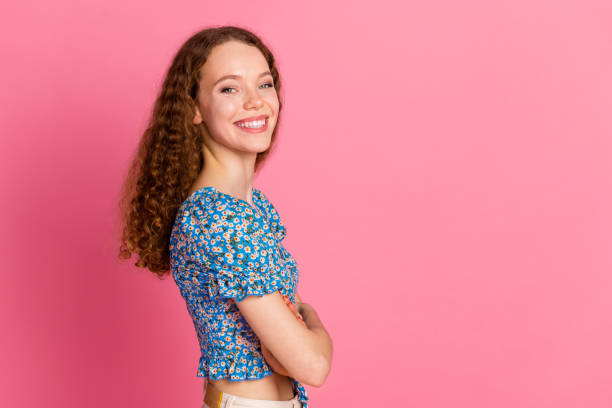 istock Happy woman smiling confidently against a pink background 2191376805