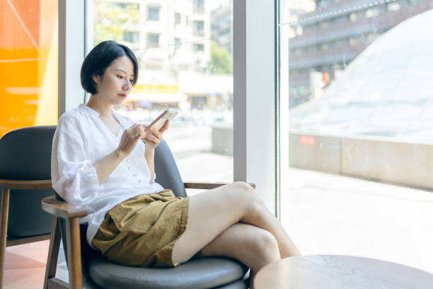 istock oung woman using mobile phone in cafe 2191378850