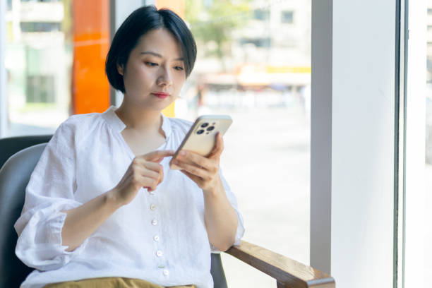 istock oung woman using mobile phone in cafe 2191378852