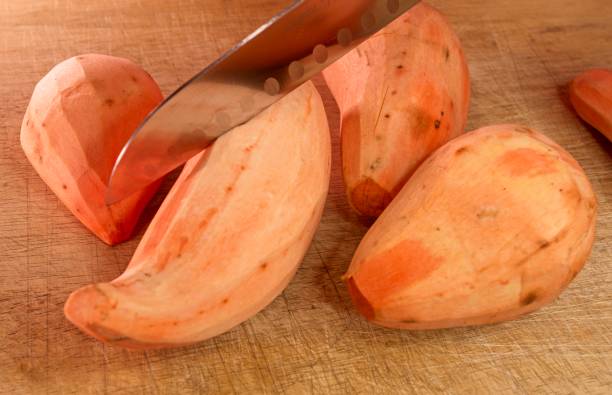 istock Peeled Sweet Potatoes on a cutting board 2191378893
