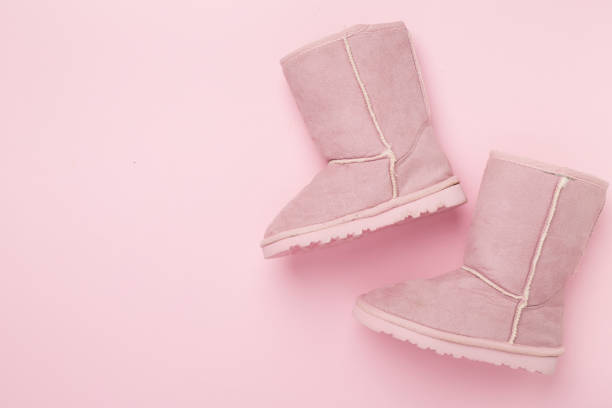 Beautiful childish boots on color background,top view