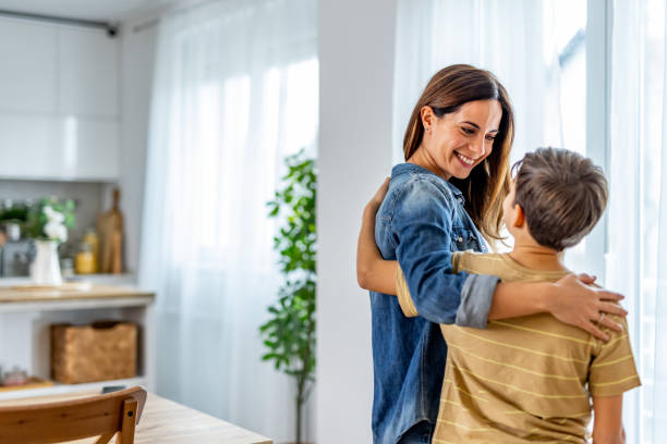 istock Loving Mother Hugging Her Child in a Cozy Home Environment 2191381013