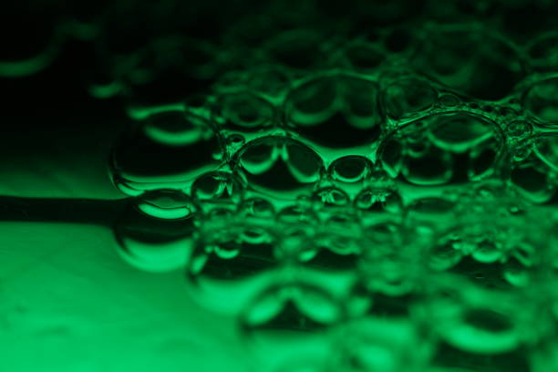 fluid movement, dark fantastic background, transparent oil bubbles, chemical reactions