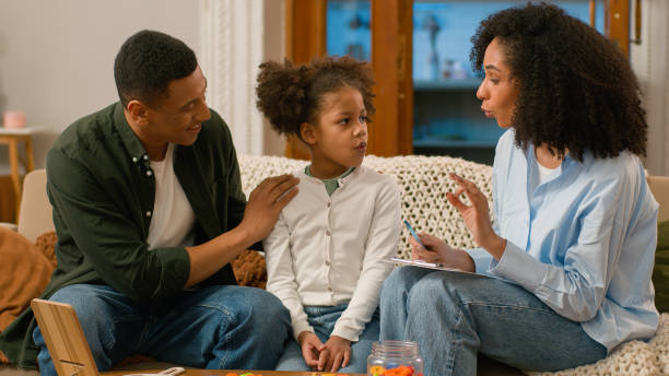 istock African American doctor speech therapist teaching treat child pronunciation problems defects sounds letter syllable word alphabet man woman together learning parenting mother father daughter educate 2191381479
