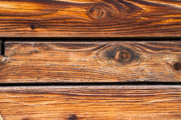Horizontal dark retro boards with knots for use as a background for graphics.