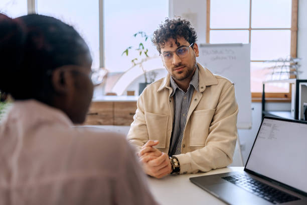 istock Two young business colleagues discussing work at the office 2191381766